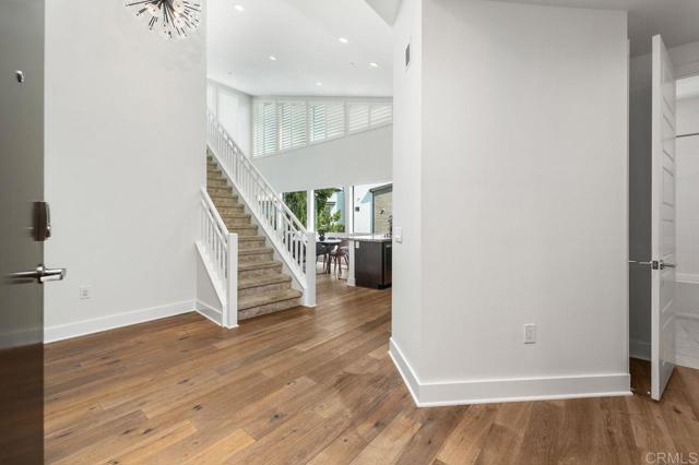 View from front door; stairs to upper level FR & large deck. Beds #2 & #3 located to the right.