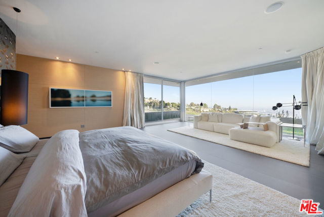 1610 Carla Beverly Hills, California Nestled on Trousdale Estates' hillside, this Beverly Hills jewel presents an awe-inspiring 180-degree vista panoramic view stretching from downtown LA to the enchanting Catalina Island, adored from the infinity edge pool/jacuzzi and the inviting Primary suite within the 5-bedroom modern villa. Steve Hermann's redesign prioritizes harmonious indoor-outdoor integration and abundant natural light. This residence embodies luxury intertwined with modern conveniences, impeccably suited for its prestigious setting. The property features an expansive yard, Poliform kitchen/closets, Crestron home automation, Vantage lighting, and top-tier finishes, culminating in an emotionally compelling masterpiece of flawless design.