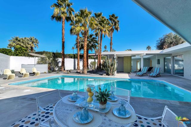 This one of a kind gated Mid-Century property by Richard Leitch has been meticulously renovated keeping the integrity of the original home and time period. The house was taken down to the studs with great care to keep as many of the original elements from when it was built in 1956. Plenty of room in this spacious 2,781 sq.ft. home with 3 bedrooms and 4 bathrooms. There is an attached art studio with outside access and inspiring pool views. Property is situated on an oversized corner lot of 13,068 sq.ft. Once you walk into this home, you will be welcomed by the grand features including 2,500 sq.ft of Italian Terrazo flooring, mostly original glass walls and sliders with their original handles. The centrally located original Atrium brings ample light into the living areas. The original Fireplace in the living room is a main focal point and very characteristic of the era. The custom flooring, tilework and colors were carefully considered. Other features include WaterWorks and California faucets, custom walnut cabinetry, Quartz waterfall kitchen counters, fabulous backsplash, wine refrigerator and classic Big Chill appliances. Upgrades include new roof, new gaslines and the new copper plumbing and upgraded new electrical were installed in a modern way out of sight. Soak in the spa like tub of your master bath surrounded by custom Lazer-cut tiles and quaint builtins - Some vanities feature their original framing and knobs. From the interior of the house, swoon at the new sparkling pebble tech pool, landscaping and lighting. there are sunny and shady areas to lounge Poolside. Indulge in the majestic snow-capped mountain views and towering palm trees. Enjoy the warm desert nights while stargazing. The exterior features over 2,800 sq.ft of new concrete and a drive-thru 4 car garage with their original garage doors for the car enthusiast. There are multiple private outdoor spaces for entertaining. Each room has outdoor access encompassing the indoor-outdoor feel that is highly desirable. With the extensive attention to detail and custom features, this home is a must see!