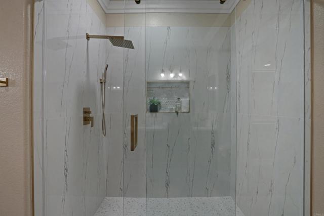 Frameless Shower with 2 feet by 4 feet tiles.