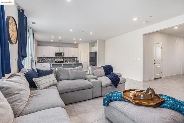 Living room featuring light tile patterned flooring and recessed lighting