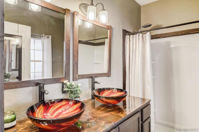 Dual glass sinks in primary bathroom in 2nd home.