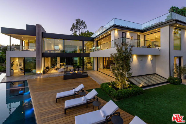 Exceptionally engineered, state-of -the-art architectural home situated in Beverly Hills featuring a seamless indoor /outdoor lifestyle with jetliner views from Century City to the Pacific Ocean. Combining an elegantly warm organic curation with cutting-edge technologies is the latest Masterpiece from Jae Omar Designs. With a culmination of the rarest, most unique materials and finishes sourced from around the globe this modern technologically advanced smart home boasts impressive scale rooms with high ceilings throughout, a 10 car gallery garage, soundproof Dolby Theater, world class gym with spa, Luxurious Master suite with showroom quality closet & spa inspired bathroom, impressive water and fire features, a rooftop terrace, temperature controlled wine room, cigar lounge and much more. Within minutes to the Beverly Hills Hotel and Rodeo Drive, this property affords its buyer the finest living experience possible surrounded by the finest dining and leisure Beverly Hills has to offer.