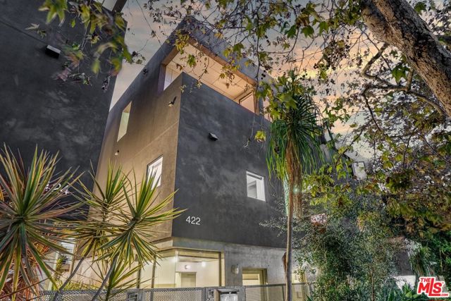 422 South Venice Boulevard 1 Venice, California Welcome home to this amazing opportunity to reside in the famous Venice Beach area! This beautifully designed property by renowned R&D Architects, known as the Venice Beach Boxes, imbue luxury and coastal flair in excellent form. This 3 bedroom, 2.5 bathroom home offers 1,956 sqft of amazing architecture and delightfully inviting details. An elegant combination of concrete and glass floors along with a stunning marble fireplace in the living area make this a showstopper. Skylights abound and allow tons of natural light which perfectly highlights the open floor plan that seamlessly flows into the newly remodeled and sophisticated kitchen featuring stainless steel appliances, brilliant quartz countertops, and tons of natural light. As you make your way to the upper levels, sunlight illuminates from above and welcomes you to the master en suite bedroom. A relaxation haven is found in the ensuite primary bathroom featuring a jetted tub, walk-in shower, and dual vanity sink. The downstairs area has its own separate entrance, providing the ideal separation for the perfect live/work setup. Enjoy a morning cup of coffee on the upper balcony or host wine and cheese nights with friends on the private rooftop deck with panoramic and unobstructed views of city lights and the Santa Monica mountains. This modern townhouse is located 3 blocks from the beach, steps to the Venice Canals, and a short walk to Abbot Kinney! Conveniently features an in-unit laundry area, tons of storage space, and 2 tandem parking spaces.