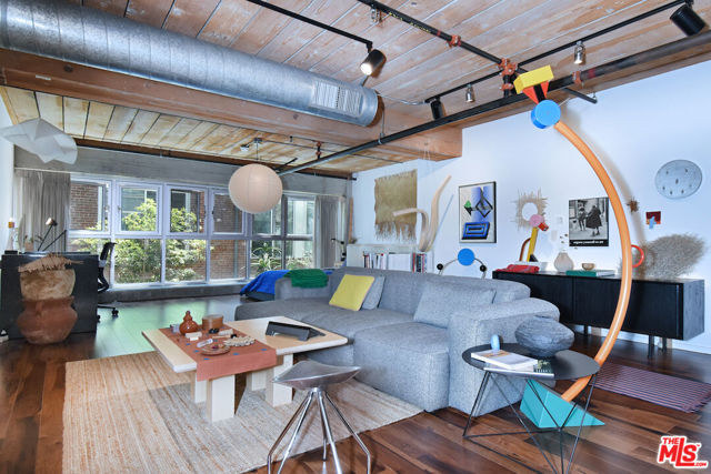 Come home to peace & quiet in this sophisticated east-facing live/work loft with an artistic aesthetic at Barker Block: the premier residence in DTLA's Arts District. There are a variety of textures in this spacious open floor plan home including century old wood posts, beams & rafters; the upgraded hardwood floors; a S/S gourmet kitchen featuring granite countertops, a dramatic subway tile backsplash & under / over the cabinet LED lighting; a cozy, unique window ledge offering views of the trees outside which provide a natural privacy screen. Then there's the huge designer bathroom with its glorious soaking tub. Other noteworthy features include the in-unit side-by-side laundry closet with storage plus two spacious mirrored wardrobes and a covered, assigned parking space. There is 24/7 security and added safety cameras throughout the building. Amenities include a state-of-the-art rooftop fitness center, along with a sky deck offering a heated pool & hot tub, cabanas, BBQs, fire pits, dining areas & breathtaking views of the downtown skyline. On the ground floor, there is an inviting courtyard lounge with fireplace and dining areas. For residents who wish to go online while outside, there is free common area WiFi. This home is located just steps from Urth Caffe, the LA Cleantech Incubator, the Arts District Park and the exciting new Sixth Street Viaduct (plus soon-to-come 12 acre park below). Central to all Fwys.; near USC; walk to SCI Arc, Spotify, Warner Bros. Music, SOHO House, award-winning 5 star restaurants like The Girl & The Goat and Bavel, music venues, taverns and all things hip and trending. Come home to Barker Block, a piece of living history that exemplifies the burgeoning community of art, culture, and entertainment in downtown LA. Enjoy the 3D Tour:  https://my.matterport.com/show/?m=A8Tc9b8nbnD