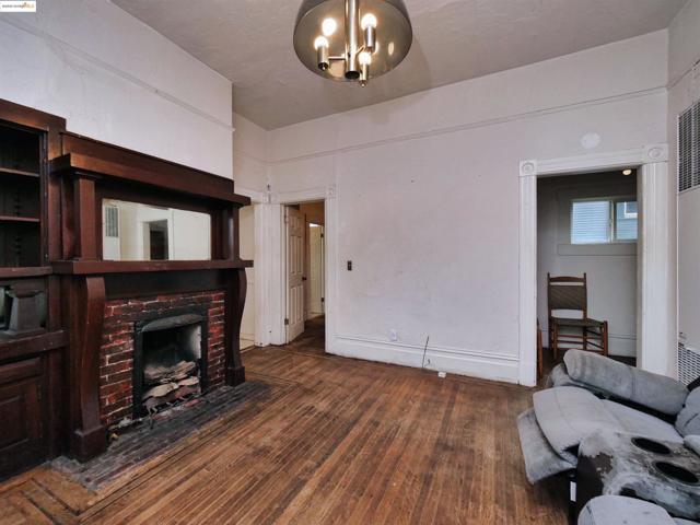 Living area featuring dark wood finished floors, a fireplace, a chandelier, and a heating unit