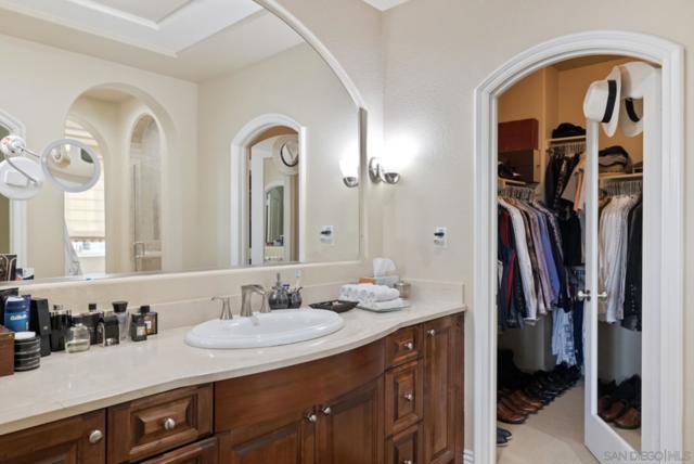 Primary Bathroom features dual sinks, large walk in shower, soaking tub, vanity and dual walk in closets.