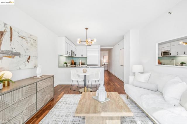 Living room with a chandelier and dark wood-type flooring