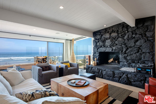 Beautifully appointed Malibu Beach House located in the heart of Broad Beach. Enter via a rare garden courtyard with beautiful string line positioning and mesmerizing unobstructed ocean views.  Once inside, floor-to-ceiling beachfront windows envelop the incredibly large open living room and gourmet kitchen with natural light. This perfectly situated beachfront retreat is an ideal place for entertaining. A huge ocean front deck overlooking the beach and a large oceanfront patio opening to the beach, offers the perfect setting for enjoying the stunning sunsets.  The Large master bedroom directly looking at the water brings the tranquility of a luxury spa experience.  Comfortably accommodate guests in the stylish guest house below the 3-car garage. This exceptional oceanfront property with encompassing ocean views is the essence of the Malibu lifestyle.