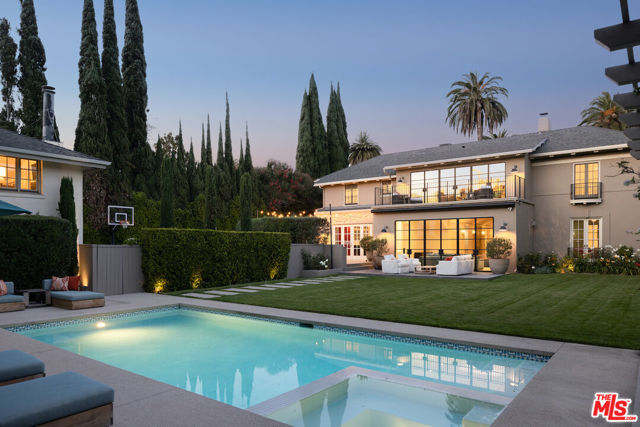 435 S Plymouth Boulevard Los Angeles, California Tucked behind the lemon trees on a palm-tree-lined drive in the prestigious Windsor Square lies this exquisitely updated 1917 traditional. Teeming with original detail yet equipped with all the modern conveniences you could ever need, Plymouth melds old-Hollywood glamour with right-now appeal. The grand entrance spotlights classic elements, like barrel ceilings, intricate crown molding, along with gorgeous original fireplaces throughout reminiscent of decades past. On the main level, French doors open to a formal living room, a substantially sized office that can be used as a screening room or library, and a formal dining concealing a hidden, speakeasy-style bar. Look beyond the impressive French steel doors in the family room to find a sprawling backyard surrounded by towering magnolia trees and manicured hedges offering plenty of privacy. The gourmet kitchen has a butler's pantry and plenty of storage, and flows seamlessly into an outdoor patio fitted with a pizza oven for alfresco entertaining under the stars. Upstairs, there's a spacious primary suite with dual bathrooms and dual walk-in closets, a second primary guest bedroom with an en-suite bathroom plus laundry room, along with two additional guest suites connected by a jack-and-jill bathroom. Walk downstairs, and you'll find a subterranean gym space along with a bathroom and laundry room. Perched above the garage is a detached guest house equipped with a kitchenette and full bathroom. Walking distance to Larchmont Village, this is *prime* Hancock Park living.