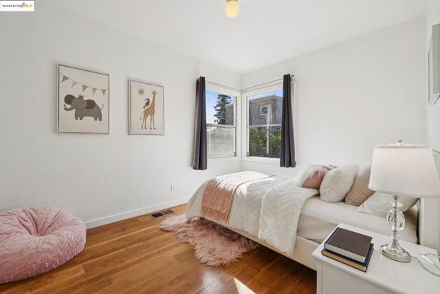 Bedroom with wood finished floors and baseboards