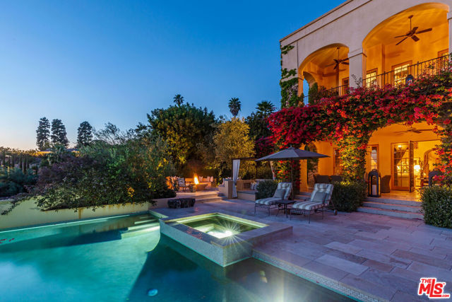 This Mediterranean dream villa is the perfect retreat from the buzz of the city. Soaring ceilings greet you in the foyer of this ocean view Tuscan oasis in Beverly Hills. Rich hardwood floors and warm touches throughout. The entire upstairs is the grand primary bedroom suite which features a fireplace, an attached den/office with incredible views, and dual bathrooms with large walk-in closets. Step out onto the stunning loggia to take in views of the Pacific. Downstairs includes three-bedroom suites,  as well as a maid's room and bath. Dine in luxury with a well-appointed chef's kitchen, stainless steel appliances, and an oversized island that flow into a large family room with fireplace. Entertain family and friends in the spacious dining room or the expansive living room with a large scale fireplace and French doors that open up onto the deck and incredible view. Out in the lush garden, bougainvillea vignettes a sparkling pool and spa. Grand fire pit with ample seating area and covered patio are perfect for sunset soirees and sensual staycations alike. Property also includes a whole home backup generator as well as an option to participate in the community's armed guard patrol.