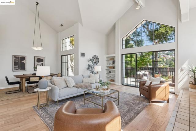Living room featuring high vaulted ceiling and light wood finished floors