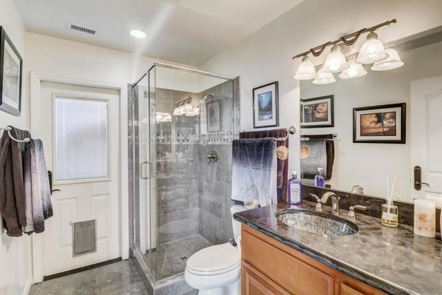 Downstairs bathroom in 1st home. Gorgeous porcelain flooring and shower, glass sink.