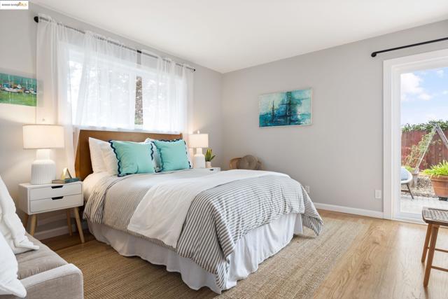 Bedroom with wood finished floors and access to exterior