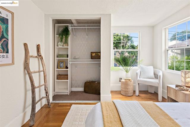 Bedroom featuring wood finished floors, a textured ceiling, and a closet