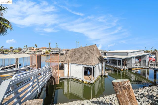 Dock area with a residential view and a water view