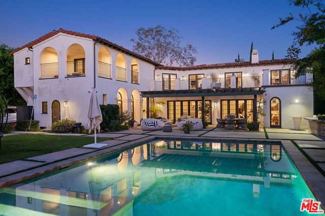 165 S Hudson Avenue Los Angeles, California Designed by architect Paul Williams, this magnificent timeless estate was built in 1927. The home was remodeled on one of the most desirable streets in Hancock Park, a highly affluent area. Behind the large gates features over 9,000 square feet of opulent living space on an approximately 20,000-square-foot lot. The property is truly one of a kind. As you enter through the double-height ceiling foyer, you are greeted with two versatile formal living spaces with two fireplaces overlooking the lush, secluded grounds. Coffered ceilings on the lower living spaces, a large kitchen, a separate dining area, and an attached bar. Entertainment system throughout the home, including the exterior. Wire-brushed oak cabinets with Calcutta marble/Oak countertops, this kitchen also features double ovens, dual sinks, Thermador appliances, and warming drawers. With a California basement. The main suite is upstairs with an en suite bed/bath + Den. The primary bedroom has a fireplace and a generous custom walk-in closet. There's also a balcony overlooking the secluded backyard to capture the afternoon sun, a stand-alone soaking tub with double sinks, and a skylight in the shower. Engineered French Oak & Italian Limestone floors throughout the home. The upper level features five bedrooms with en suite, a washer & dryer up and down stairsMaid's quarters with a full bathroom with a separate entry. Externally, off-the-living areas get swept away to an exceptional super private patio overlooking an oversized sparkling pool & spa with water features & fire pit surrounded by mature trees with feature-up lighting and manicured lush lawns. Fully functional BBQ area, W/2 car garage/ gym/ bonus storage.