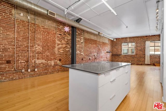 BEST PRICE in the Arts District!  Imagine the endless design options in this open and airy space for live/work in the heart of the Arts District. This highly coveted, corner-unit is 1,150 square ft. Features include exposed brick walls, high ceilings, hardwood floors, an abundance of storage and built-in shelving, parking, gym, and a community rooftop pool. A perfect spot to call home, a work studio, an income property, or an easy and low maintenance pied-a-terre, in the heart of it all.  Your options with this space are endless.  These 1920 warehouse's are full of history and character and this bright, rare end-unit is is the perfect spot to soak it all in with endless opportunity. Close to Spotify, Urth Cafe, Cafe Gratitude, Bestia, Bavel, The Girl and the Goat, Zinc, Hauser and Wirth and so many more of the city's best restaurants and art galleries, and a dog park too!
