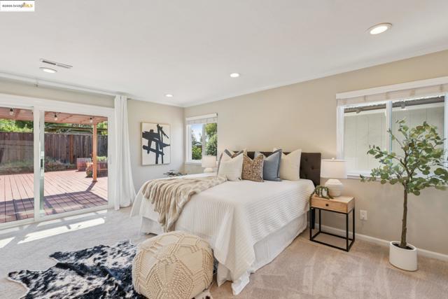 Bedroom featuring access to outside, carpet flooring, crown molding, and recessed lighting