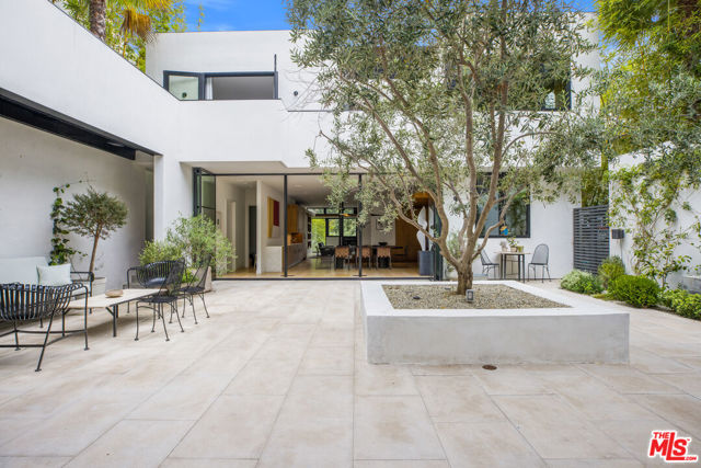 634 Kingman Avenue Santa Monica, California Beautiful contemporary in the highly coveted Santa Monica canyon. This sensational 4 bedroom, 5 bathroom home, completely redone in 2016 and designed by Josh Greene, is surrounded by secluding landscaping with treetop views. Within the home, an alluring and open courtyard takes you out of Santa Monica and into your own personal resort. Greeted with the seclusion of a gate and the grandness of a beautiful oversized door, the home features generous indoor-outdoor dining and entertaining spaces. You will be stunned by the contemporary details abounding with natural light throughout. Entering into the kitchen, one is greeted with a newly renovated, remarkably exquisite kitchen and island featuring top of the line appliances. Greenery pokes throughout with large windows showcasing the trees and plants the property sits on, including your own private garden where the possibilities of flowers, herbs, and fruits are endless. This sensational contemporary perfectly depicts a life of luxury in Santa Monica all while being mere minutes from the beach.