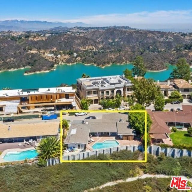 In the coveted Bel Air area sits a spacious contemporary single-story home above the canyon. With 4 bedrooms, a maid's room, and a garage converted into a bonus room, there is plenty of space for hosting guests. The flow from each living area to the backyard, featuring a sparkling pool, is ideal for entertaining purposes. Enjoy endless views of the canyon that will leave anyone breathless.