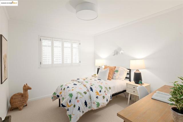 Carpeted bedroom featuring ornamental molding and baseboards
