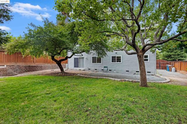 Rear view of house featuring crawl space, stucco siding, and a patio area