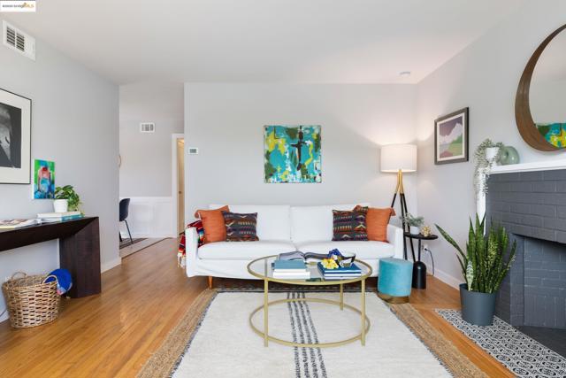 Living room featuring a brick fireplace and wood finished floors