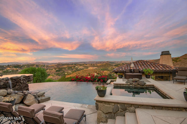 Secluded, private Luxury Estate nestled in the Thousand Oaks hills above the Santa Rosa Valley. Built in 2010 and reimagined from 2017-2021  Approx. 7,374 Sq. Ft, 5 Bedrooms with 7 Baths on 6.82 acres, this gated estate is an entertainer's dream encompassing both indoor & outdoor living spaces with 180-degree views of the Santa Rosa Valley from just about every room! This estate is perfect for elegant or casual entertaining.  As you make your way through the formal entry that boasts custom picture windows providing magnificent views you enter the chef's kitchen that features excellent storage and top-of-the-line stainless steel appliances and flows into the family room featuring a floor-to-ceiling stone fireplace and exposed wood-beamed ceilings. On the main level, you have the stunning primary bedroom and primary bath, office, formal dining room, family room, and gym. On the lower level, there are three en-suite bedrooms, a Home Theater room, and a second family room.  Live the SoCal lifestyle while relaxing in the entertainer's backyard featuring an infinity pool, swim-up bar, cascading waterfalls, water slide, and breathtaking views. There is also a 5-car garage to store all your cool toys. This Luxury Estate is a must see to appreciate all that it offers. Schedule a private showing today!