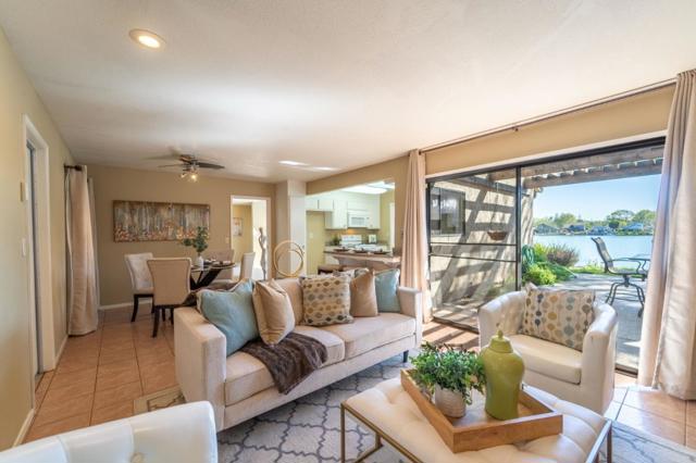 Family room with views of the lake. Kitchen nook in the background w/ kitchen to the right.