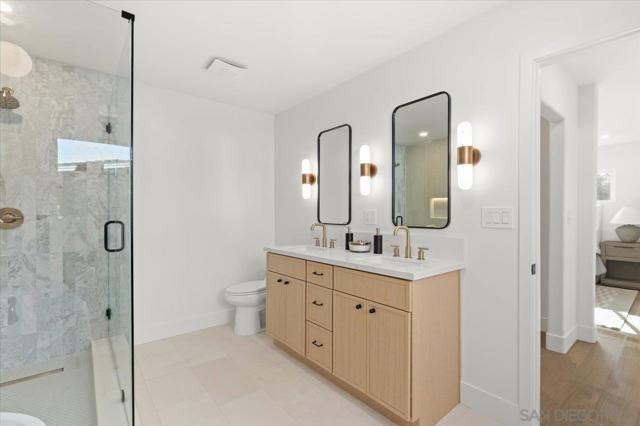 Spa-like en suite bath with dual vanities, a walk-in and freestanding soaking tub. Designed with incredible attention to detail with impressive features such as limestone flooring, marble tile and a lighted niche in the   shower.