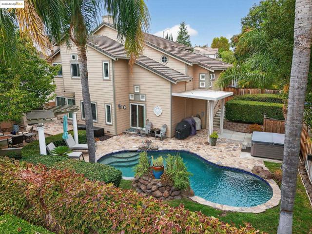 Rear view of house with a patio, a tiled roof, an outdoor living space, and stairs