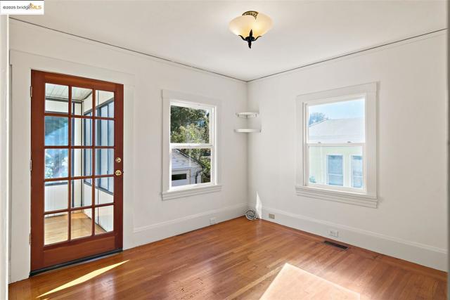 Spare room with light wood-type flooring and baseboards