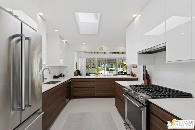 Walnut-toned cabinets are juxtaposed against high-lacquered white cupboards for a clean, contemporary look.