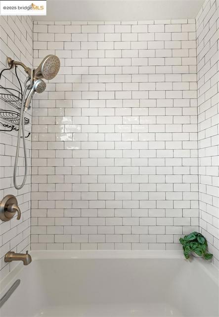 Bathroom featuring washtub / shower combination