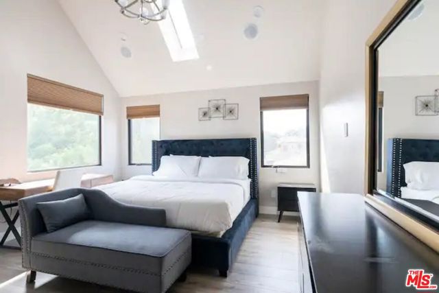 Bedroom #5 is the master bedroom and it has a king sized bed, large dresser, and couch