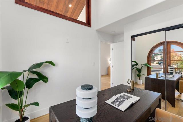 Large bedroom with custom wood french doors allowing ample natural light thoughtfully positioned in the house.