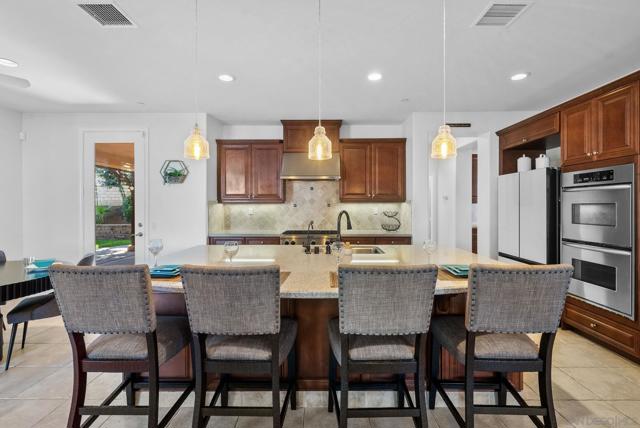 Eat in kitchen with oversized island, double ovens, chefs dream.