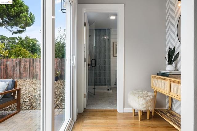 Bathroom featuring light wood-type flooring and a stall shower