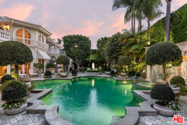 815 Cord Circle Beverly Hills, California Nestled in the heart of the Estate Section of prime Beverly Hills, this palatial residence features over 13,300 sq.ft. of soaring ceilings and voluminous rooms. Crafted with no expense spared, this property is perfect for grand entertaining, yet architected with an unexpectedly practical floorplan for everyday living. Double height foyer with stained glass dome and imperial-style staircases. The main living room features 14 ft ceilings, wood-burning fireplace and epic scale adjacent family room with adjoining bar. Formal dining room with seating for 16 guests and an octagonal junior dining room. A total of 8 bedrooms including 2 staff rooms. The primary suite is a world apart with dual marble baths and sitting room. A variety of thoughtful elements include pool-accessible full bath, upstairs and downstairs laundry, elevator, pool/tv room, wine closet, gym, and split parking with two gates. Sited on over a 1/2 acre with complete privacy, the grounds are magical in every sense featuring a Roman style pool, fresco paintings and formal gardens. Shown only to prequalified buyers.