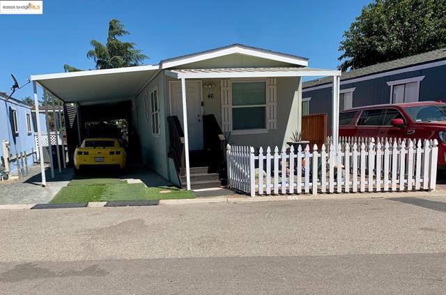 Manufactured / mobile home featuring an attached carport