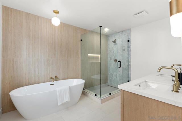 Spa-like en suite bath with dual vanities, a walk-in and freestanding soaking tub. Designed with incredible attention to detail with impressive features such as limestone flooring, marble tile and a lighted niche in the   shower.