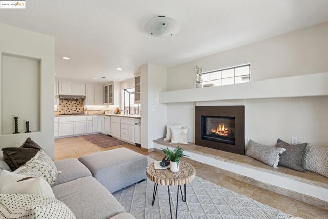 Living room with recessed lighting and a glass covered fireplace