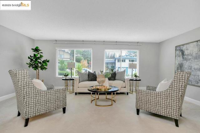 Living area featuring baseboards and carpet flooring