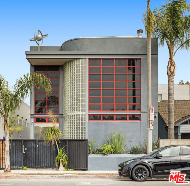 217 Windward Avenue Venice, California This Iconic BAUHAUS influenced architectural gem of a property, has not been on market for 20 years! This very special DUPLEX /HOME/OFFICE property is situated next to the famous Hamma Sushi restaurant on the Venice Circle with a view of the ocean and Venice sign from its rooftop office. LOCATION! LOCATION! One of the best most convenient locations in Venice... Post office, bank, fine dining, shopping, night life , Abbott Kinney two blocks away and also the beach and ocean bike path are two blocks away. A secure gated entry leads you inside to the vault like front door into the main level with soaring high ceilings, lots of natural light pours inside the wall of glass block, rich bamboo floors are a nice detail, with a minimalist stainless steel fireplace and zebra wood accent on kitchen bar that over looks a private courtyard that makes this a great home for entertaining guest. Also on the main level is a bedroom and a bathroom. This home has custom inset bookshelves and storage for art, sculptures or a library. As you go upstairs you reach the mezzanine level that overlooks the living room and has a great view of the circle and city and spiral stairs up to the office and roof deck. The primary bedroom boasts all pocket doors and high ceilings with huge closet and separate bath tub and shower, it is adjacent a nice room that was used as a art studio and gym. As you go outside second level you can cross bridge to separate two bedrooms and full bathroom with their own living room and second small kitchen, also has its own secure entrance separate from the front, ideal for many possibilities, this is a very unique -MUST SEE- property. This part sits above a three car garage with electric or hybrid charger built in for easy convenience. Come experience coastal living at its best with gorgeous sunsets, surf and ocean breeze. Make this your home or live / work office in the most spectacular beach in the world renown for its creativity and home of celebrity artists, musicians and more.