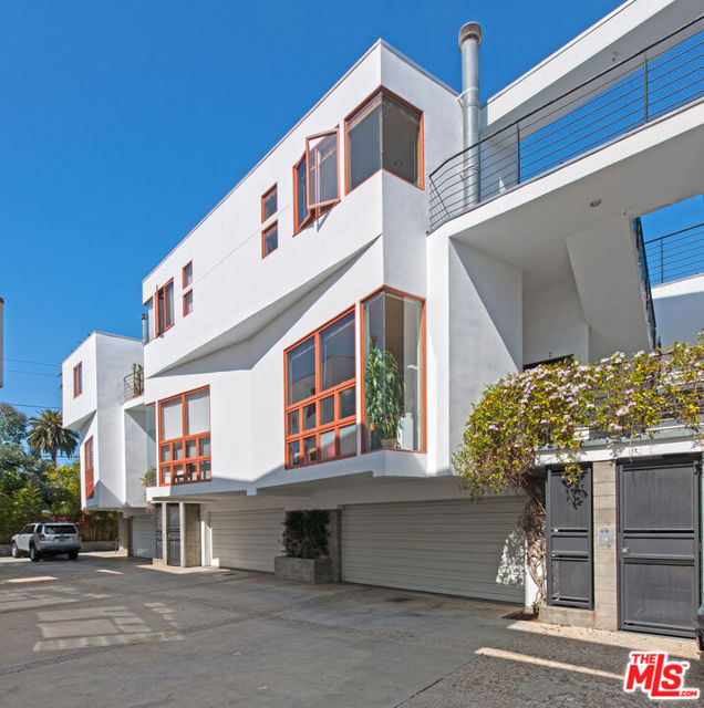 Come see this end unit architectural townhome located just half a block from hip Rose Avenue shops, restaurants and cafes. This unique property features a grand open floor plan that is great for entertaining, live/work, or the beach lifestyle. The main level features an open kitchen, living, 1/2 bath and work room design. Unit also features high ceilings, large windows, and a wood burning fireplace. Second level features two spacious master suites with private bathrooms. Enjoy easy access rooftop deck, great for you morning coffee or a sunset Happy Hour. Thoughtful design and beautiful natural materials with concrete, slate and hardwood floors throughout. Bottom level features large direct-access two-car garage (garage additional 507 sq. ft.) with plenty of storage and laundry. Additional secured parking and guest spots on property. Walk to Rose Avenue, Abbot Kinney, Main Street, the beach, Whole Foods & numerous other amenities.