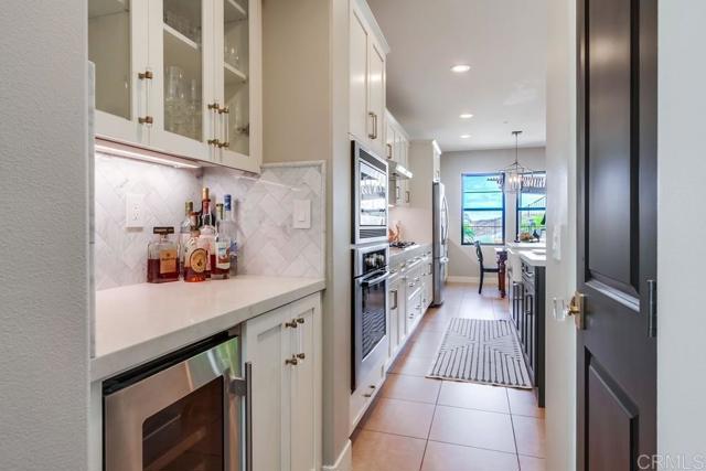 mini butlers area with wine fridge, cocktail or coffee area and walk in pantry