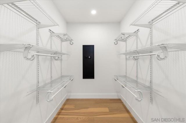 Large walk in closet with security safe.