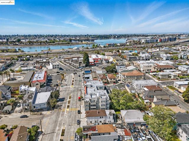 Aerial view of property's location featuring a large body of water and nearby urban area